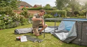 Someone assembling a Bestway Steel Pro MAX pool on a lawn.