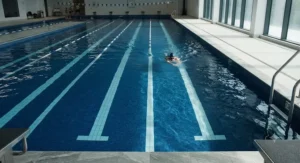 A close-up view of a deep rectangular pool for lap swimming featuring distinct lane markings.