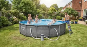Family splashing and having fun in a Bestway Power Steel 14ft pool with pump installed in a British garden