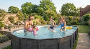 A family enjoying a sunny afternoon in their oval above ground swimming pool.