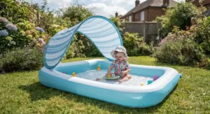 Shaded inflatable paddling pool designed for toddlers with a built-in sun canopy on grass.
