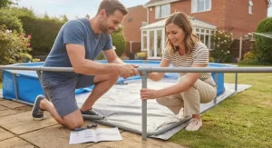 Two people effortlessly clicking together components for an easy assembly oval frame pool on a patio.