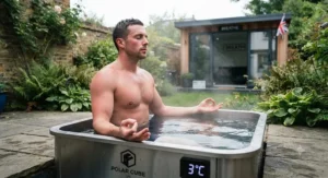 Person practicing controlled breathwork during a morning cold plunge pool for recovery session