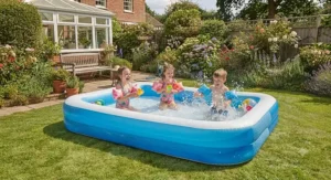 Young children splashing and playing safely in a sturdy rectangular family paddling pool on the lawn