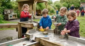 Toddlers exploring buoyancy and flow rates at a low-level early years water play centre