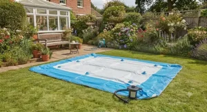 Uninflated rectangular inflatable pool laid out flat on grass ready for air pump inflation