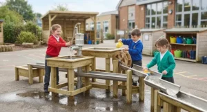 EYFS outdoor water play equipment featuring wooden water tables and pumping systems for early years development