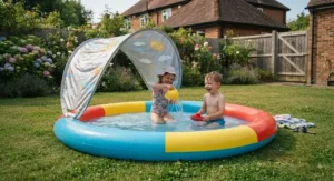 Brightly coloured inflatable paddling pool with a removable UV canopy set up on a British lawn.