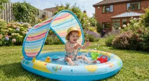 Toddler splashing safely in a shaded paddling pool with a UV protective canopy