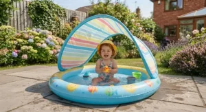 Infant paddling pool with canopy securely pitched on patio tiles during summer