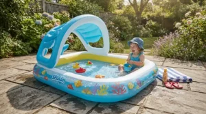 A baby pool with canopy for newborns placed securely on a paved backyard patio.