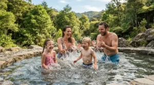 Family enjoying a heated swim current pool on a sunny weekend in the countryside